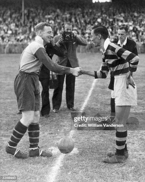 Football captains from shaking hands Fung King Cheong Hong Kong and D S Waymouth, Dulwich Hamlet FC before they 'kick off'.