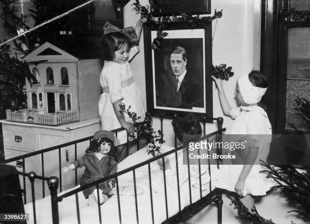 Patients in the children's ward at the Prince of Wales General Hospital, Tottenham, north London, decorating a picture of the Duke of Windsor with...