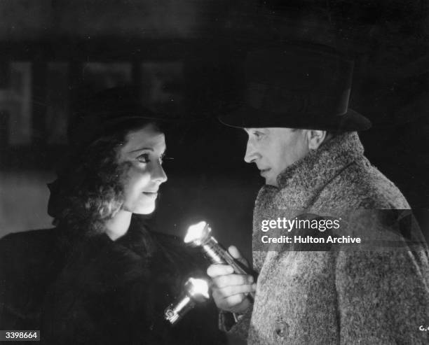 Conrad Veidt and Valerie Hobson use torches in London's blackout in the film 'Contraband' , directed by Michael Powell and produced by British...