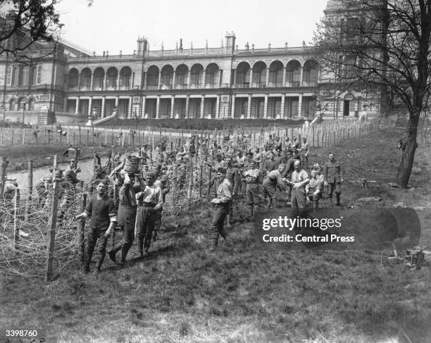 British troops erecting barbed wire enclosures outside Alexandra Palace, North London to imprison German prisoners of war.