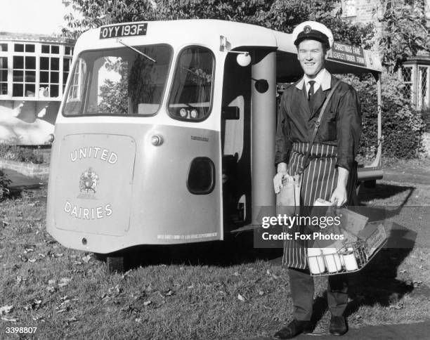 Milkman with his electric milk delivery float.