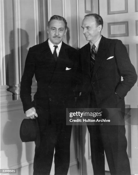 American actor John Barrymore and British musical comedy star George Grossmith on a visit to the set of the film 'The Scarlet Pimpernel' at Elstree,...