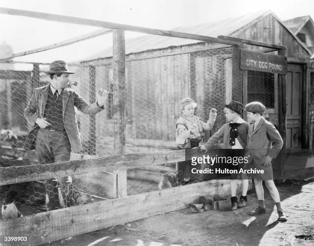 American child actors Jackie Cooper and Jackie Searl visit the city dog pound in a scene from the film 'Skippy', directed by Norman Taurog and...