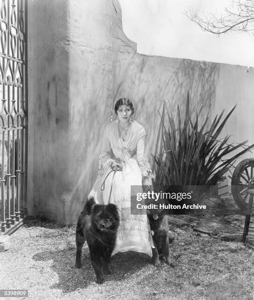 French actress Renee Adoree with her pet Chow dogs during a break in the making of the film 'The Tide of Empire', directed by Allan Dwan and produced...