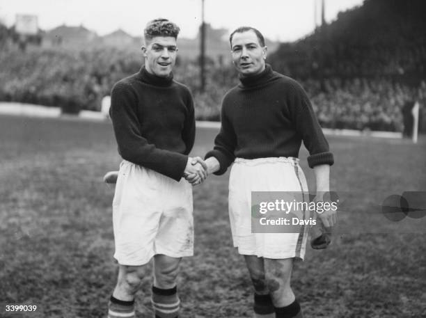 Chelsea goalkeeper Vic Woodley shakes hands with Sam Bartram, the charlton Athletic goalkeeper.