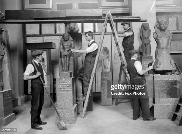 Decorators prepare an exhibition of antiquities at the Egyptian Galleries in the British Museum, London.