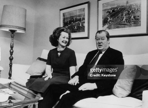 Lord Spencer and Lady Spencer sitting hand in hand in their hotel suite while on a visit to Munich. Lord Spencer is the father of Lady Diana Spencer...