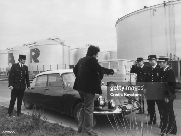 Driver pleads his case to police officers who have spotted his car parked outside the petroleum depot at Belfort, Besancon, France. Security has been...