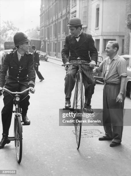 Mexican comic-actor Cantinflas practises on his penny-farthing bicycle for a scene in 'Around the World in Eighty Days', 26th August 1955. He is...