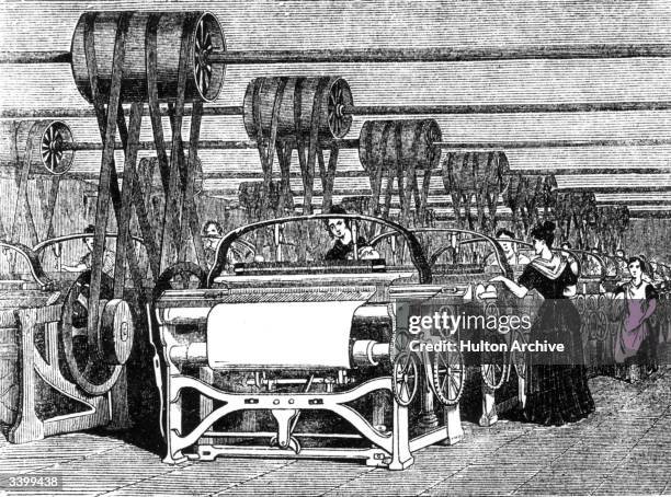 Power looms being used in textile manufacturing during the industrial revolution.