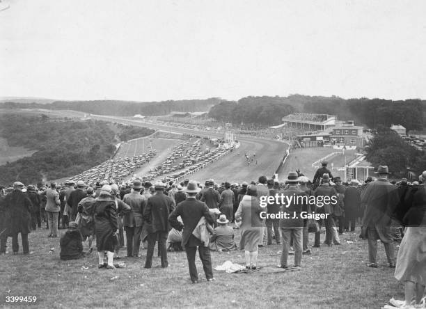 Spectators watching a race at Goodwood from Trundle Hill.