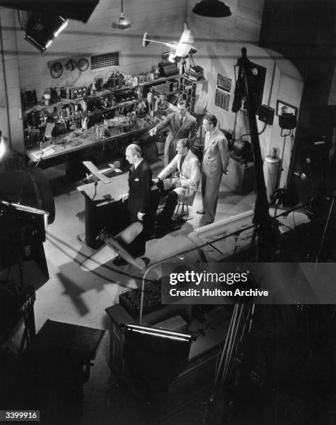 Actors Ed Stanley, George Pease, William Gargan and Kent Taylor rehearsing a scene for the Paramount aviation drama 'The Sky Parade'.
