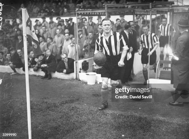 Grimsby Town FC team captain , Hall, leads his team out on to the pitch.