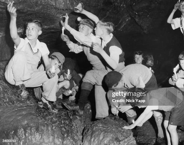 Party of school boys on holiday camp exploring the newly-discovered passage at Bagshwe Cavern, Bradwell, Derbyshire, which experts believe leads to a...