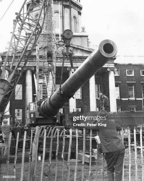 Work continues on the task of hoisting the two 15 inch naval guns from battleships Resolution and Ramillies into place as permanent exhibits outside...
