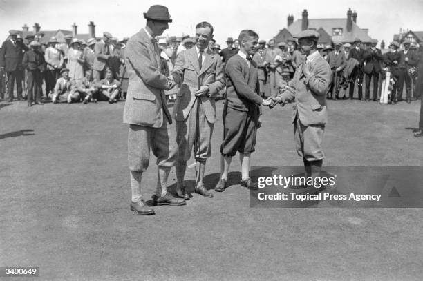 International golf at Hoylake Gordon Simpson shaking hands with Charles Evans and Bobby Jones shaking hands with Jenkins.