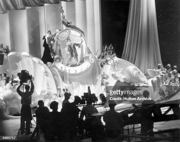 Cast and crew filming a scene for 'The Great Ziegfeld', a biopic of the Broadway impresario Florenz Ziegfeld, directed by Robert Z Leonard for MGM.