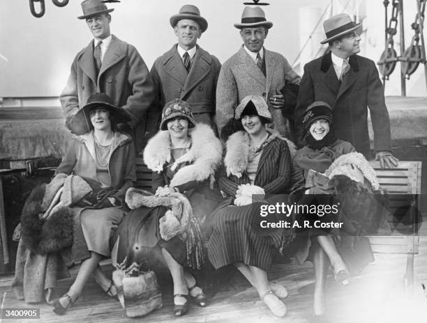 Four Honymoon couples from New York Giants and Chicago White Sox baseball teams on board the deck of a ship. Mr and Mrs Huntzinger, Mr and Mrs...