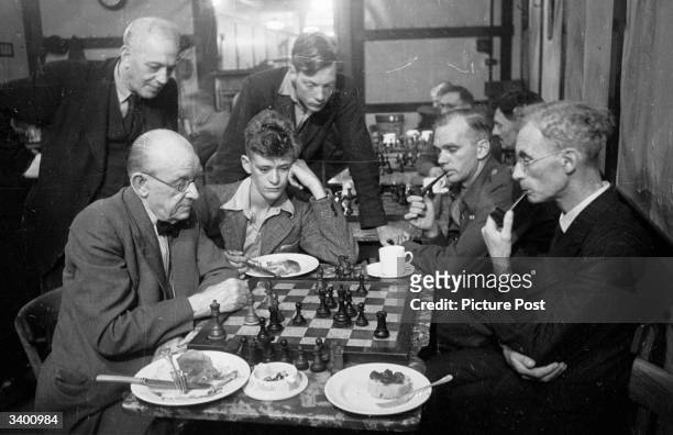 Group of chess players at the Gambit restaurant in London, where customers play chess over lunch. Original Publication: Picture Post - 3057 - Chess...