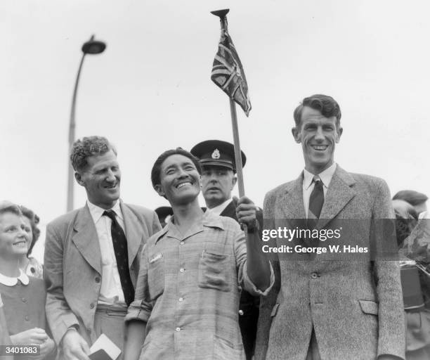 From left to right, Colonel John Hunt, Tenzing Norgay , and Edmund Hillary make a jubilant return to Britain after becoming the first men to scale...