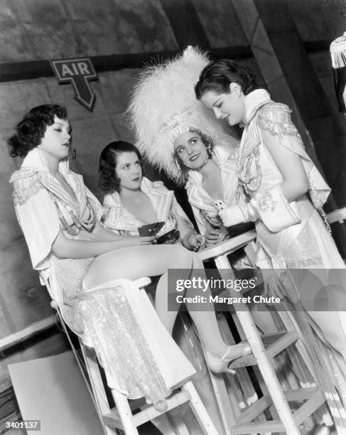 Chorus girls relax off-stage during production of the film 'The Great Ziegfeld', a biopic of the Broadway impresario Florenz Ziegfeld. The film was...