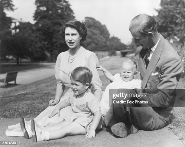 Princess Elizabeth and Prince Philip, Duke of Edinburgh with their two children, Prince Charles and Princess Anne in the grounds of Clarence House,...