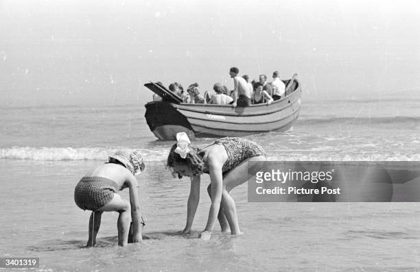Group of holidaymakers on the beach near the Butlin's Camp at the North Yorkshire seaside resort of Filey. Original Publication: Picture Post - 4136...
