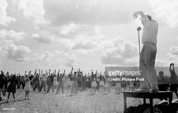 Group of holidaymakers, in the Butlin's Camp at the North Yorkshire seaside resort of Filey, keep fit in a mass exercise session. Original...