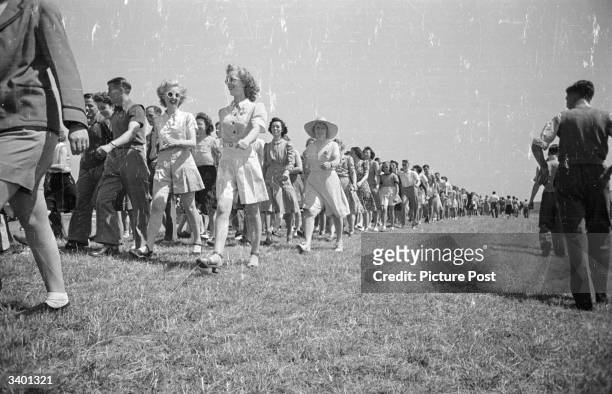 Group of holidaymakers, in the Butlin's Camp at the North Yorkshire seaside resort of Filey, set out for a ramble. Original Publication: Picture Post...