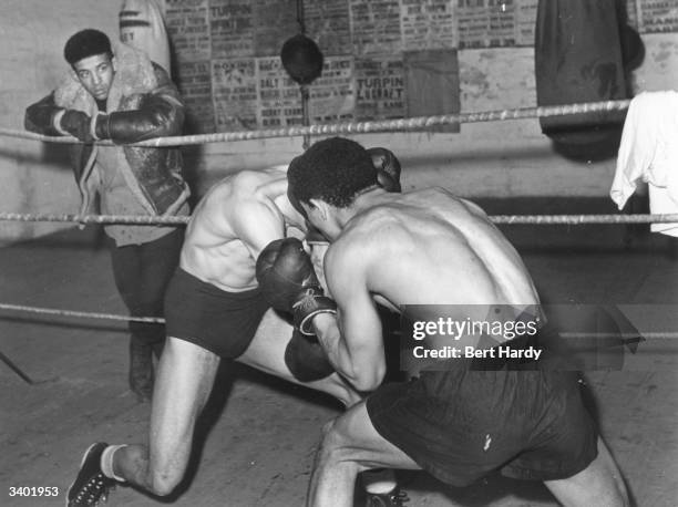 Turpin brothers having a friendly work out in the gym. On the right is Randolph and on the left, Dick. Both were at one time middleweight champions...