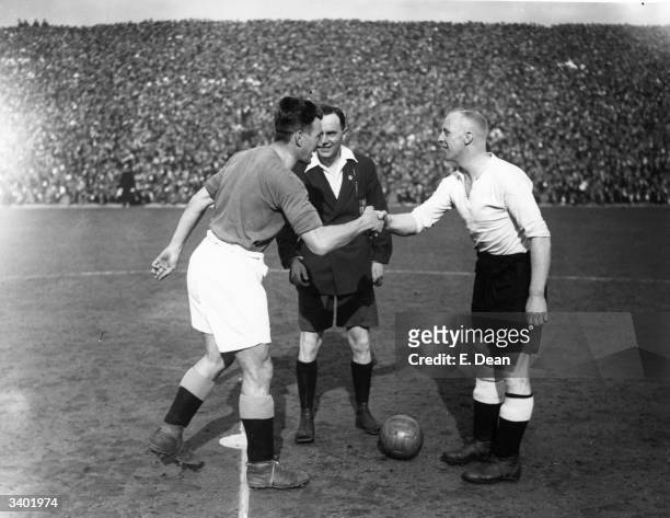 Manchester City and Derby County captains, Cowan and Cooper, shake hands in front of referee J W Lucas, beforer the kick off of an FA_Cup semi-final...