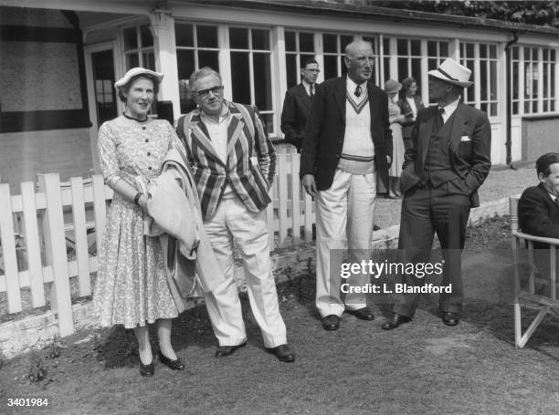 To R Mrs Don Smith, Sydney Goldsack , D R Jardine ) and Mr Don Smith seen at cricket match between Authors and the National Book League.The match is...