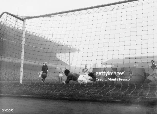 West Bromwich goalkeeper, Sanders, saves a penalty from Arsenal's Clapton as Arsenal play West Bromwich Albion at Highbury in an FA Cup tie replay.
