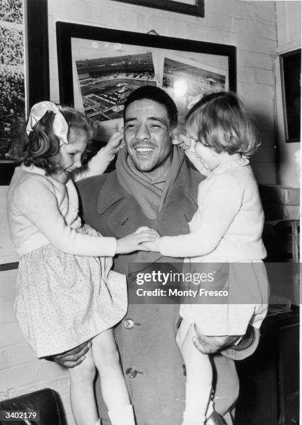 Dick Turpin's brother, middleweight boxer Randolph Turpin with two blind children from one of the Sunshine Homes.