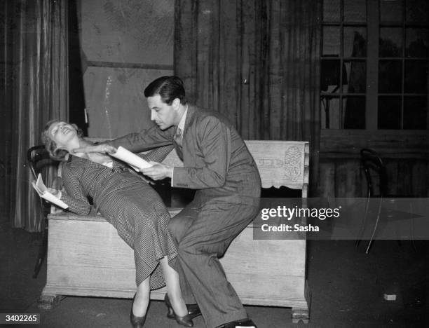 Welsh actor, dramatist and composer Ivor Novello rehearses a scene from the play 'Proscenium' with British stage and screen actress Joan Barry at the...