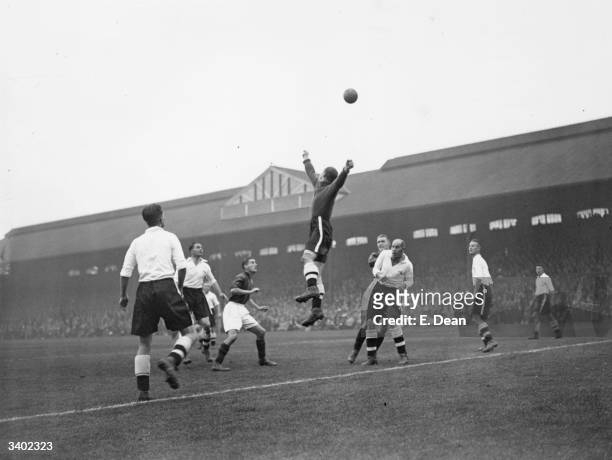 Fulham goalkeeper, Tootill, punches the ball clear from a Bradford City attack as the two teams play at Craven Cottage.