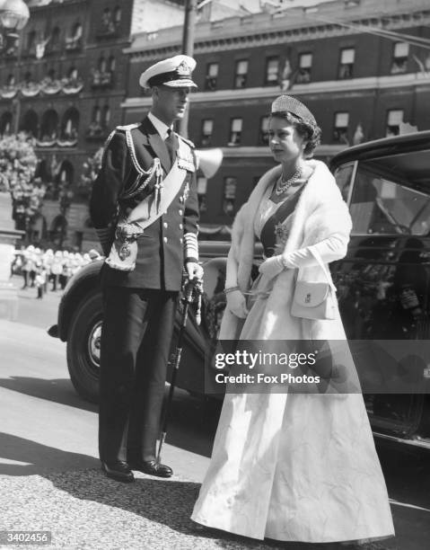 Queen Elizabeth II wearing an ivory silk gown and a diamond tiara, arriving at a State Opening of Parliament ceremony in Melbourne, Australia.