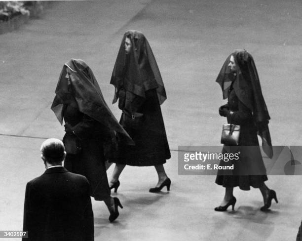 Queen Elizabeth the Queen Mother, Queen Elizabeth II and Princess Margaret attend the arrival of the coffin of King George VI at Westminster Hall,...