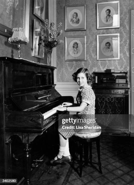 Princess Margaret Rose , younger daughter of King George VI and Queen Elizabeth, playing the piano at Royal Lodge, Windsor.