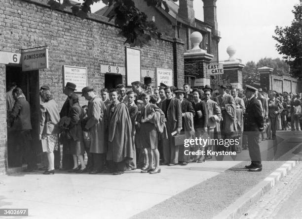 Cricket spectators queuing up at the entrance to Lord's cricket ground, London.