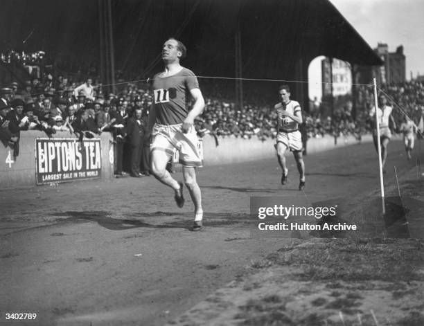 Scottish athlete Eric Liddell winning the 440 yards race at the Amateur Athletics Association championships at Stamford Bridge, London, UK. Eric...