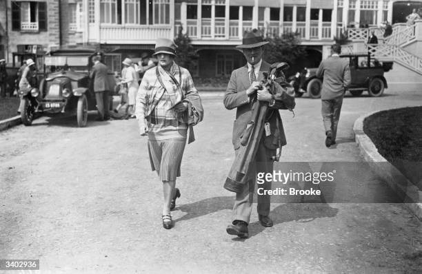 Mrs Loeffler and Commander Roger Cook arriving at Le Touquet for a game of golf during the Whitsun holidays.