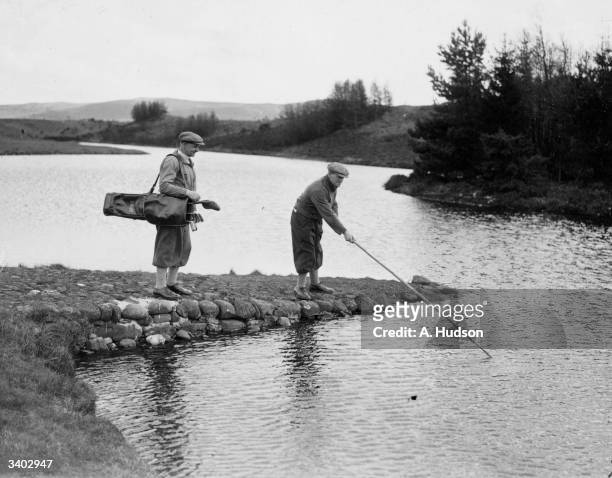 Boyland of Brassey fishing for his ball on the Queen's Course with G Aitken of Motherwell during a championship tournament on Gleneagles Golf Course...