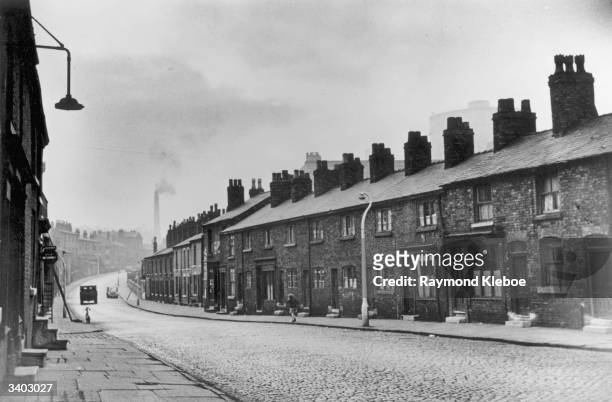Street in Stretford, near Manchester. Original Publication: Picture Post - 8127 - The Housing Jungle - pub. 1955