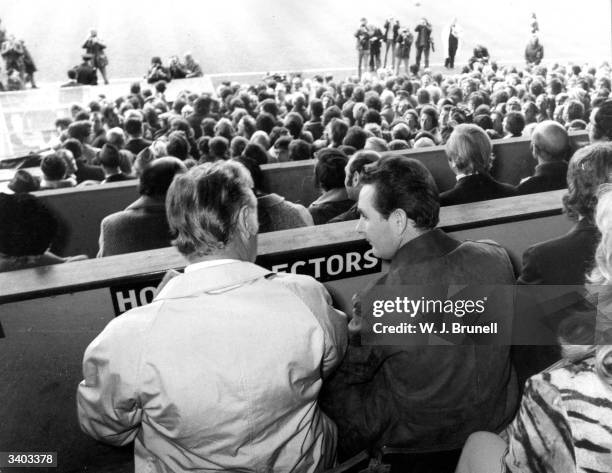 Brian Clough, manager of Brighton And Hove Albion Football Club, and his assistant, Peter Taylor, watch their team play York City from the stands.