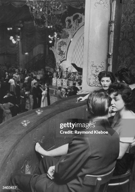 Men and women enjoy a night out at the Lyceum Theatre which has now opened as a 'Palais De Danse'. Original Publication: Picture Post - 7221 - The...