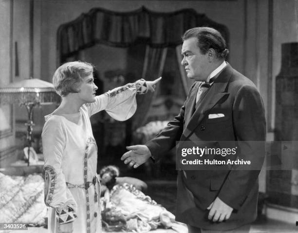 Laura La Plante orders Pat O'Malley from the room in a scene from the Universal Studios silent film, 'The Midnight Sun'.