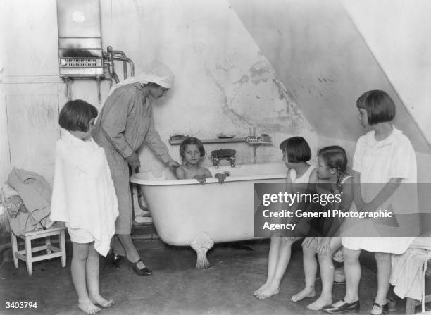 Bath time for a group of young girls.