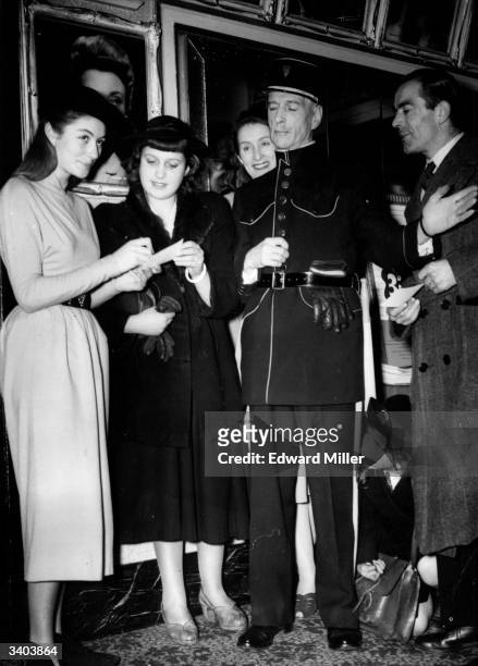 French actress Anouk Aimee signs autographs for fans at the Cameo-Polytechnic, London, during the showing of her first film to be seen in Britain...