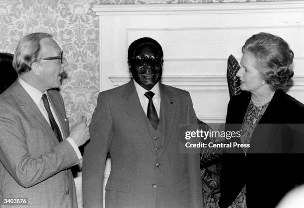 Zimbabwe's new prime minister Robert Mugabe with British prime minister Margaret Thatcher and foreign secretary Lord Carrington at 10 Downing Street,...